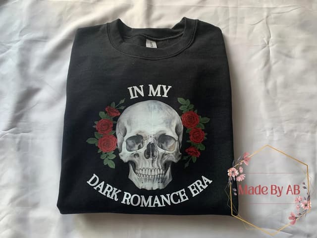 Black crewneck with In My Dark Romance Era around a watercolor skull and red roses