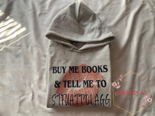 Heather gray hoodie with Buy Me Books & Tell Me To STFUATTDLAGG over a copper lipstick kiss