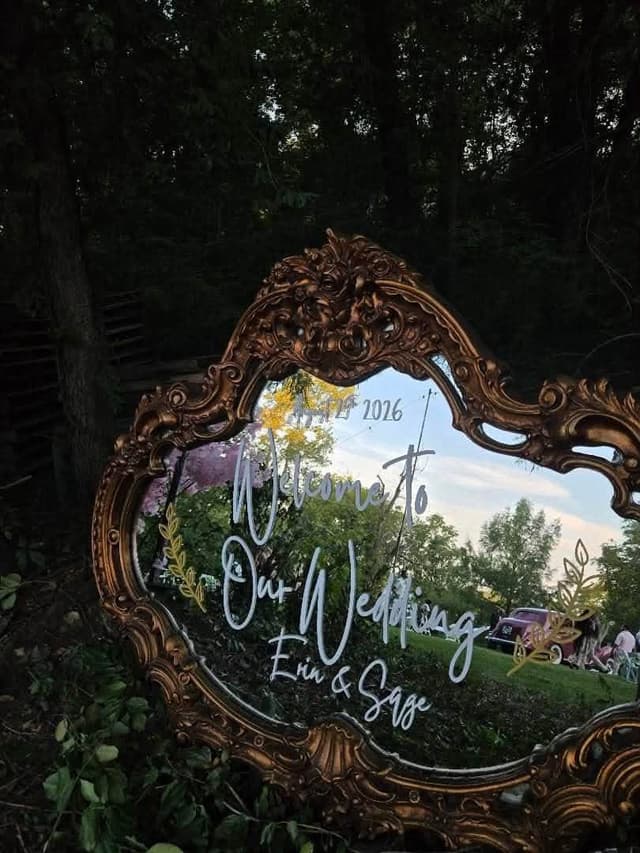 Ornate gold heart-shaped wedding welcome mirror with Welcome to Our Wedding in white script